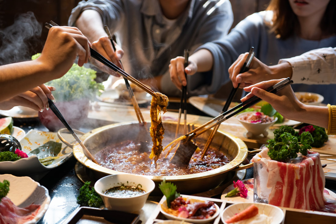 photo of people eating hotpot